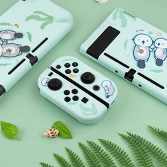 two nintendo wii game controllers sitting next to each other on top of a green surface