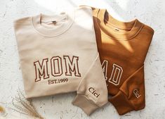 -Thank you for choosing our mother's name embroidered sweatshirt! We are committed to providing you with high-quality products and personalized customized services. -You can embroider your mother's name on the sweater to make it a unique gift or souvenir. -Multiple sizes for you to choose from, ensuring that you can find the most suitable size for your mother. -material *100% cotton material *Very soft and comfortable -Maintenance instructions *Machine wash with cold water. *It is best to wash l Grammy Gift, Mommy To Be, Mom Hoodies, Embroidered Crewneck, Mama Sweatshirt, Custom Sweatshirts, Mom Sweatshirt, Embroidered Sweater, Mens Long Sleeve Tee