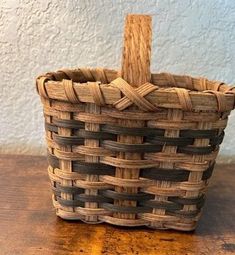 a small basket sitting on top of a wooden table