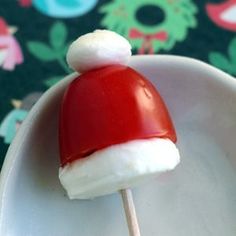 a santa hat lollipop sitting on top of a white plate