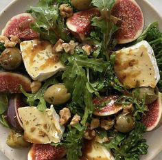 a white plate topped with figs and greens