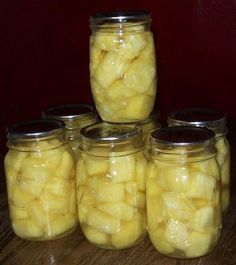 several jars filled with pickles sitting on top of a table