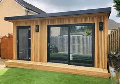 a small wooden building with sliding glass doors