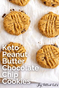 six peanut butter chocolate chip cookies sitting on top of a piece of parchment paper with the words, keto peanut butter chocolate chip cookies