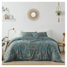 a bed with blue comforter and pillows in a room