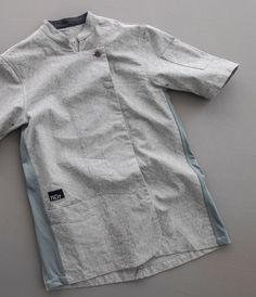 Redesigned for 2021. Our commitment to fresh design stays true with our redesigned Tilit Chef Jacket. This well tailored chef coat is packed with functional details including a front pocket at the hip, arm pocket for sharpie and/or tweezers, super soft chambray inner collar, performance fabric side panels provide stretch and airflow, side tabs for a personalized fit, split longer back for flexibility on the job, rounded front placket for style and to reduce the flap, snap front closure and of co Chefs Coat, Chef Coat Design, Chef Shirt, Chef Aprons, Chef Jackets, Chef Pants, Chef Wear, Chef Clothes, Female Chef