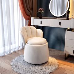 a white chair sitting on top of a rug in front of a dresser and mirror