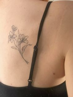 a woman with a flower tattoo on her back