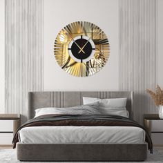 a large clock on the wall above a bed in a room with white and gray walls