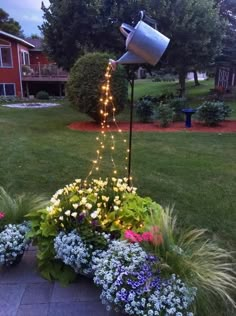 a potted planter filled with flowers and lights