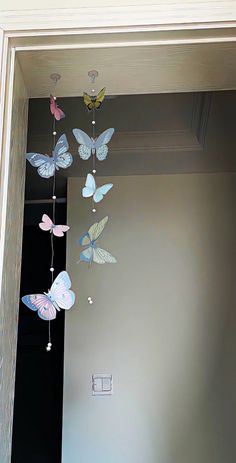 some butterflies are hanging from the ceiling