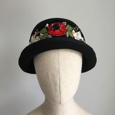 "'Poppy' is a vintage-style black wool felt cloche hat, made from new and vintage materials. Its not too hard to find a real vintage/antique hat from the twenties, and lots of them are black. That's why I decided to give this one a burst of colour, in the style of hats from the era (last image). Made from a new wool felt, and trimmed with velvet grosgrain ribbon, the hat features a spray of vintage carefully hand stitched onto the hat. All of the flowers date from the era, or before, and the shapes and colours are so intricate - the details are incredible! I have a wonderful stash of vintage flowers, and I had great fun choosing each one and making them come to life again. But lets not forget the back - a fun detail with the mitred ribbon gives the plainer side of the hat a lovely 'exit'. Antique Hat, Cloche Hats, Antique Hats, Vintage Millinery, Cloche Hat, Real Vintage, Beautiful Hats, Velvet Ribbon, Black Wool