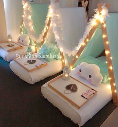 some kind of tent with lights on it and stuffed animals in the bed side by side