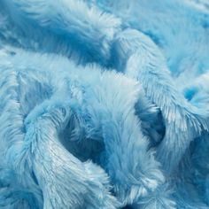 a close up view of a blue furry animal blanket that is very soft and fluffy