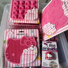 three hello kitty ice trays in pink and white boxes with hello kitty designs on them