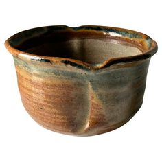 a brown and black bowl on a white background