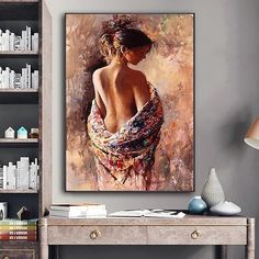 a painting of a woman's back in a dress on a wall above a desk