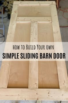 a wooden table with the words how to build your own simple sliding barn door