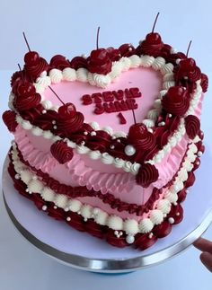 a heart shaped cake with candles sticking out of it