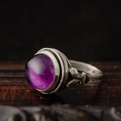 Step into a world of mystique with this sterling silver .925 victorian-inspired ring, adorned with a mesmerizing purple amethyst reminiscent of a the a crystal ball- a future-telling sphere!  Crafted with meticulous care each ring is a beauty in itself, embodying the timeless elegance of the Victorian era. Amethysts carry the power of intuition and foresight, believed to enhance spiritual awareness and inner strength.  As unique as the wearer, every ring is made to order, ensuring that no two pieces are alike.  Please note that all amethysts are natural and unique and their color may vary from light purple to dark purple. Please choose your favorite stone from the drop down menu during checkout. See last photo of the listing for details. -DETAILS- *Handmade item *Sterling silver .925 *Amet Victorian Sterling Silver Round Amethyst Ring, Hallmarked Round Amethyst Ring In Sterling Silver, Silver Amethyst Crystal Ring Hallmarked, Crystal Ball Ring, Purple Multi-stone Amethyst Crystal Ring, Antique Hallmarked Amethyst Ring In Sterling Silver, Bohemian Rings, Spiritual Awareness, Inner Strength