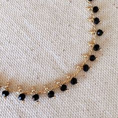 18k Gold Filled Black Beaded Bracelet Metal: 18k Gold Filled Measures 7.25 inches in total length. Weights 4.1 grams Hypoallergenic jewelry - Nickel Free Water resistant Rigorously manufactured under CA Prop 65 and EU standards Made in Brazil Black Bracelet With Gold Beads, Black Gold Beaded Bracelet, Black Beaded Chain Bracelet For Gift, Gift Black Beaded Chain Bracelet, Black Beaded Bracelet As Gift, Black Beaded Dainty Jewelry, Dainty Black Beaded Jewelry, Dainty Black Beaded Bracelets With Tiny Beads, Gold Crystal Bracelet With Round Black Beads