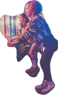 two people sitting on top of each other in front of a vending machine at a carnival