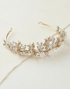 a gold tiara with crystal stones and leaves on it's headbands