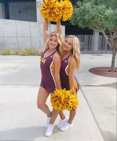 two cheerleaders are posing for the camera