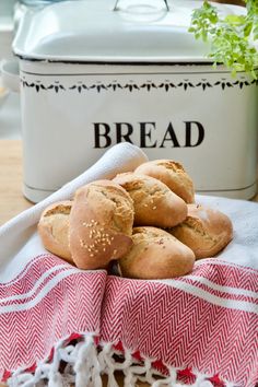 bread rolls sitting on top of a red and white towel