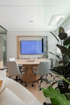 a living room filled with furniture and a flat screen tv mounted to the side of a wall