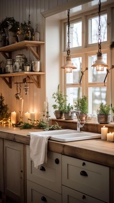 a kitchen with candles and plants on the counter