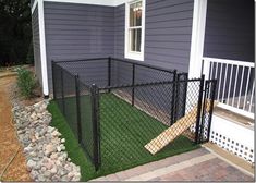 a black chain link fence in front of a house