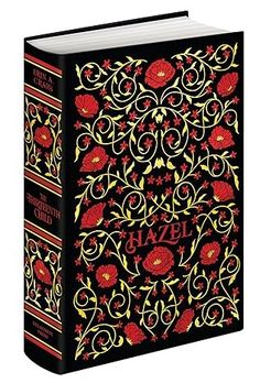 a black and red book with floral designs on the front, in gold foil lettering