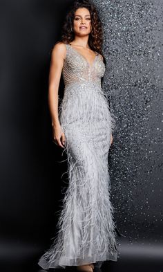 The designers at Jovani bring you this gorgeous long prom dress so that you can celebrate your special evening knowing you look spectacular. This amazing long evening gown showcases a beaded sheer-illusion bodice and a feather embellished floor length skirt that are sure to impress at prom, a military ball, or another formal event. The bejeweled bodice has a sheer inset at the deep v-neckline and shoulder straps that lead to the open back that adds a sexy look with every turn. Smoothing over the Prom Dress With Feathers, Feather Prom Dress, Dress With Feathers, Feather Gown, Light Blue Prom Dress, Green Homecoming Dresses, Blush And Grey, Formal Dresses With Sleeves, Embellished Skirt