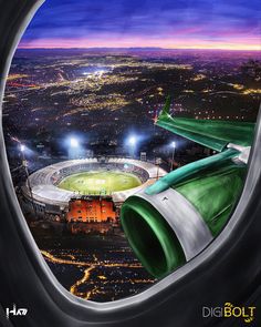 an airplane window with a view of a stadium and the city lights from inside it