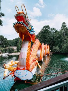 an elaborate dragon float floats in the water