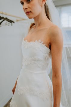 a woman wearing a wedding dress and veil