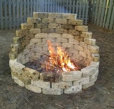 an outdoor fire pit made out of bricks