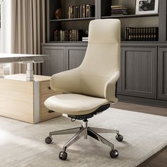 a white office chair sitting in front of a book shelf with books on top of it