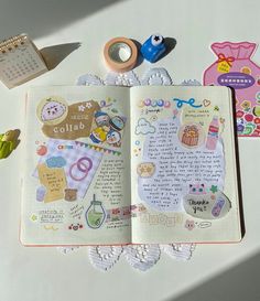 an open notebook with stickers on it next to scissors and other crafting supplies