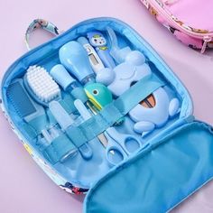 a blue bag with toothbrushes, combs and other items in it sitting on a table