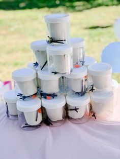 there are many plastic containers stacked on top of each other at the wedding reception table