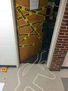 a classroom door decorated with caution tape