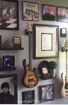 a wall with guitars and pictures on it