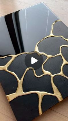 a black and gold table with an apple logo in the center on top of it