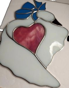 a stained glass piece with a heart on it