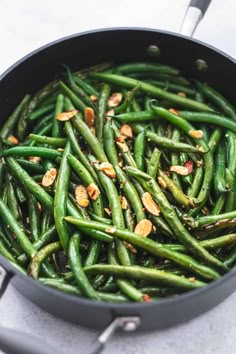 cooked green beans with almonds in a pan