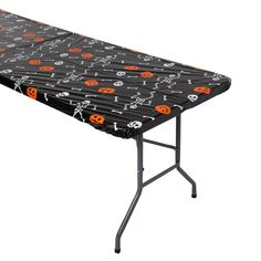 an ironing board with skulls and jack - o'- lanternes on it