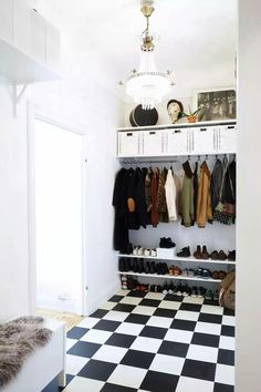 a white closet with black and white checkered floor