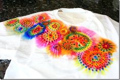 a t - shirt that has been dyed with different colors and designs on the front